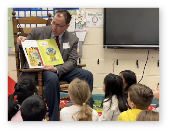 Dr. James Kirsch reading to elementary students for Read Across America.